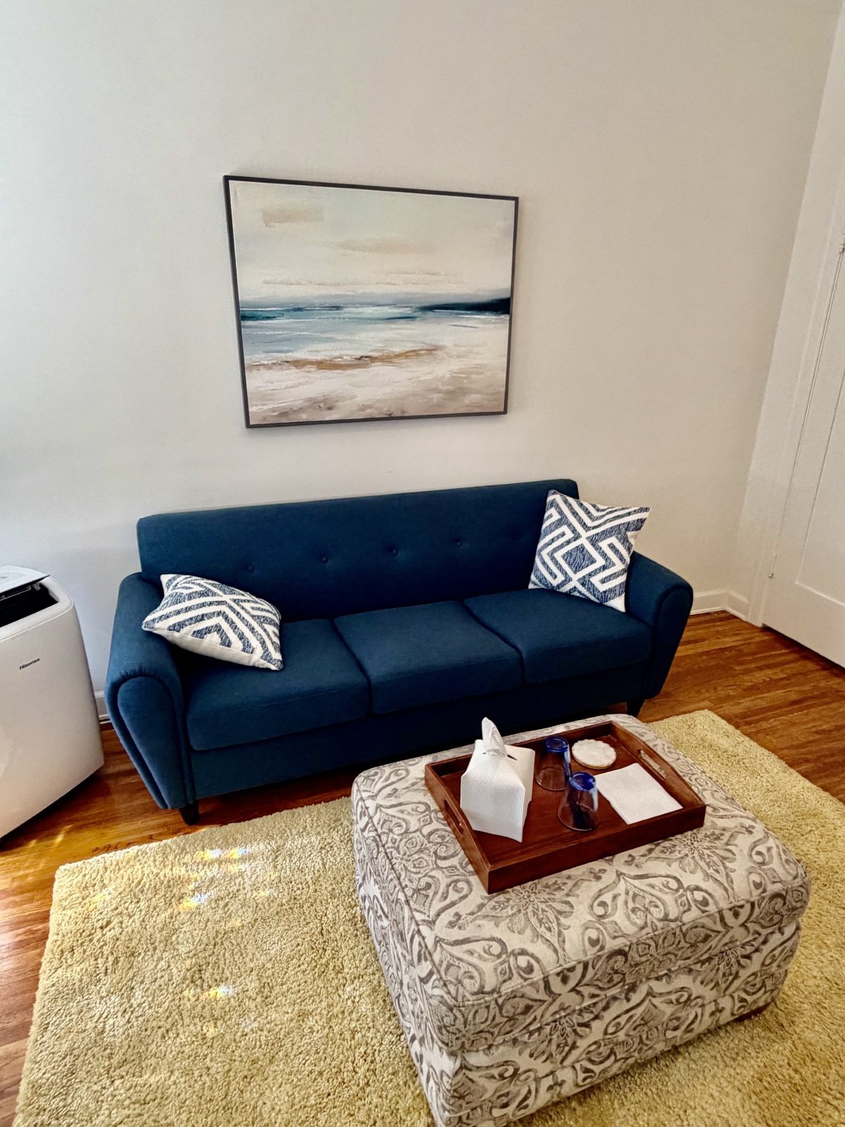 Mateo Leonardo's therapy office in Long Beach, a quiet room with a blue couch and a painting of the shoreline